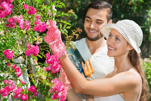 Gardener maintaining a vibrant garden in Hornsey