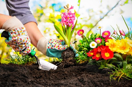 Landscaping crew managing site risks and protective gear on an outdoor job